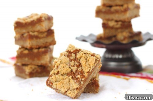 Golden brown Dulce de Leche Bars stacked on a small pedestal dish, inviting a bite
