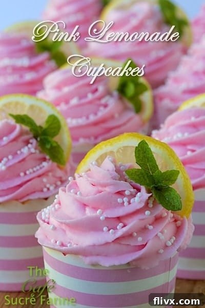 Pink Lemonade Cupcakes garnished with lemon slices and mint