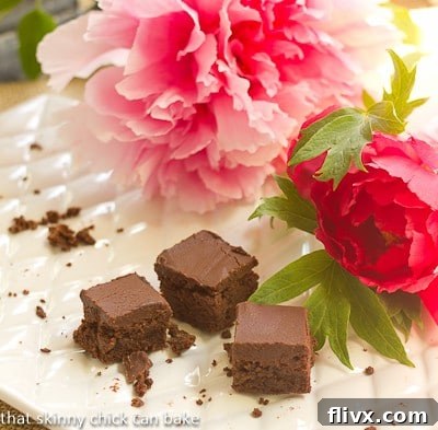 A nearly empty platter of Refrigerator Brownies with some pink peonies