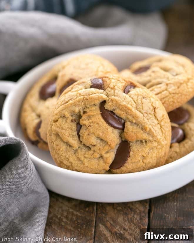 Brown Butter Chocolate Chip Cookies in a white bowl, showing their golden edges and melty chocolate