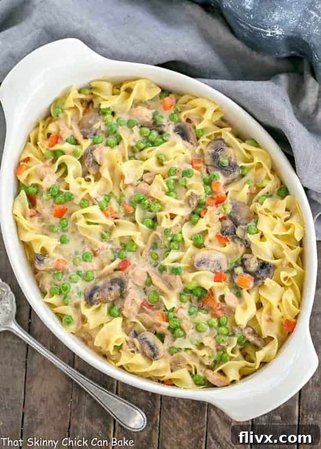 Tuna Noodle Casserole from Scratch in an oval white casserole dish, bubbling and golden brown