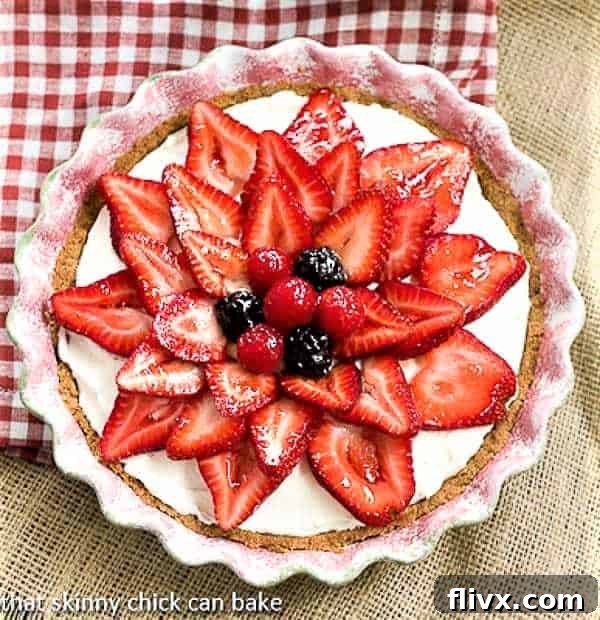 A stunning Strawberry Cream Cheese Pie in a ceramic pie plate, ready to be sliced and served.