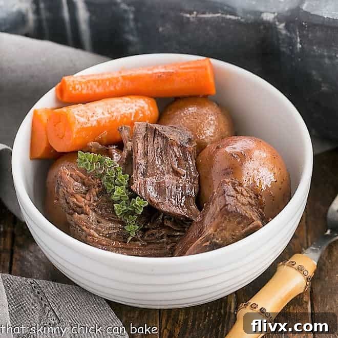 A glistening bowl of Instant Pot Beef Stew, showcasing tender beef, vibrant carrots, and small potatoes, garnished with a sprig of fresh thyme, ready to be served.
