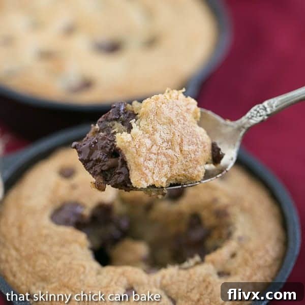 A beautifully baked Skillet Chocolate Chip Cookie in a small cast iron pan, ready to be enjoyed