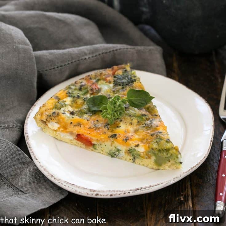 Roasted Broccoli Frittata slice on a round white plate, garnished beautifully
