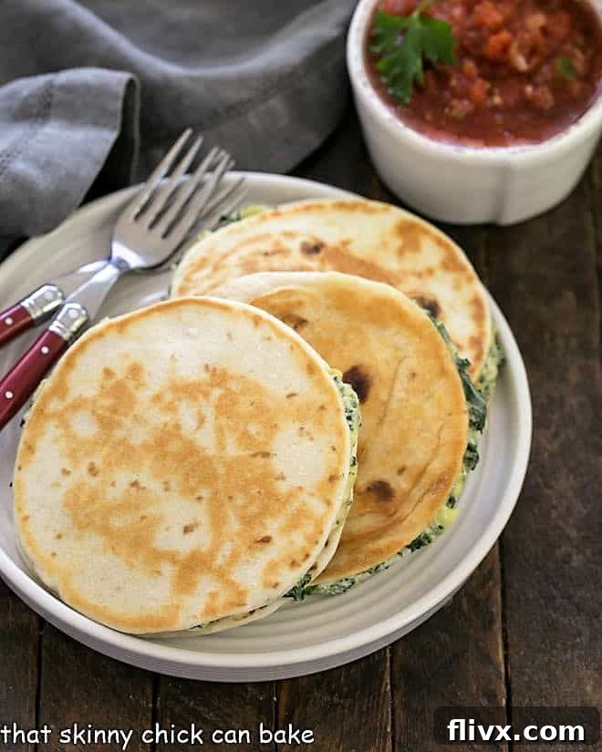 Three perfectly golden-brown quesadillas neatly arranged on a white plate, accompanied by two stylish red-handled forks, inviting a delightful culinary experience.