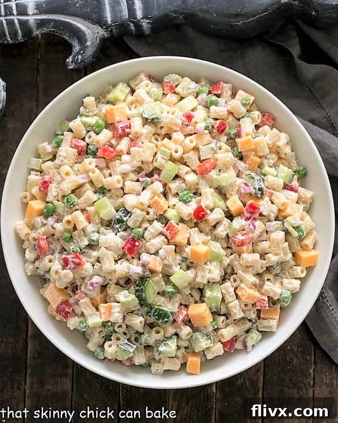 Overhead view of a vibrant Vegetarian Pasta Salad in a large serving bowl, showcasing fresh ingredients.