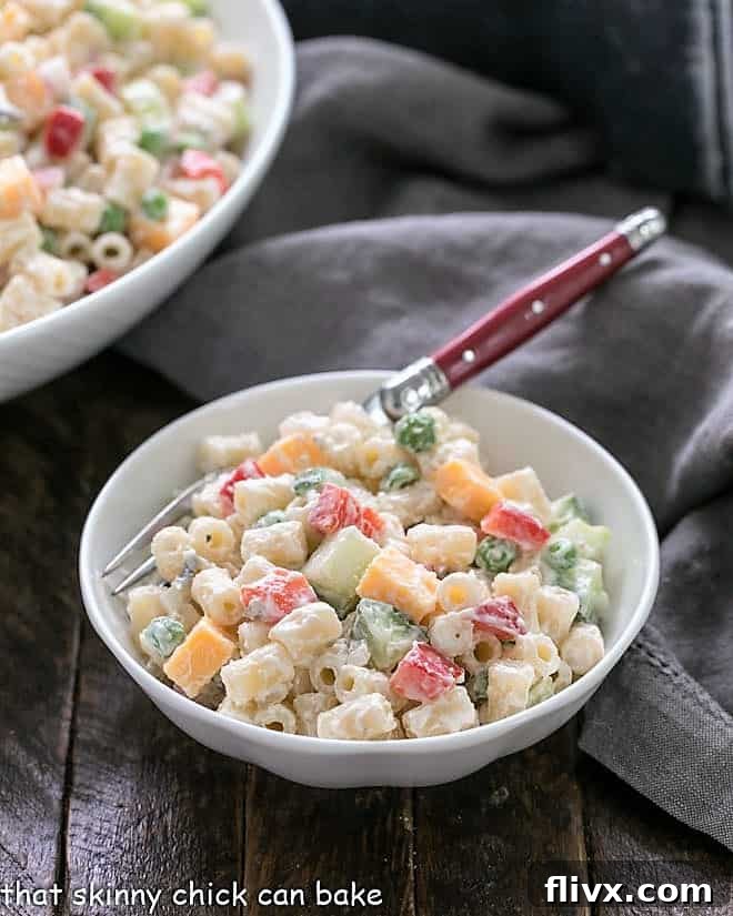 Easy pasta salad recipe served in a small white bowl with a charming red-handled fork.