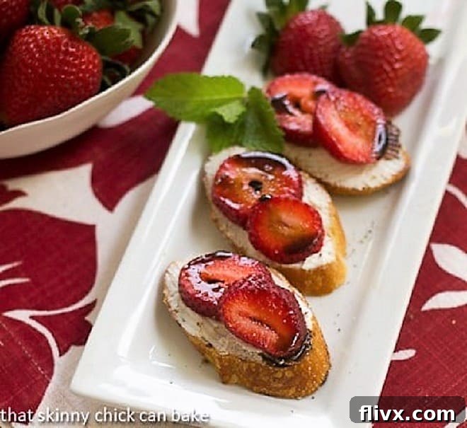 Strawberry Toasts topped with goat cheese, sliced berries and a drizzle of balsamic vinegar, ready to be served.