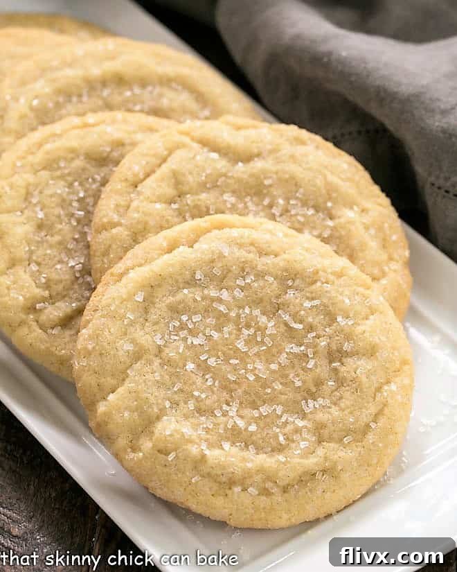 Staggered Giant Sugar Cookies on a white tray, showcasing their soft texture and crunchy sugar coating.