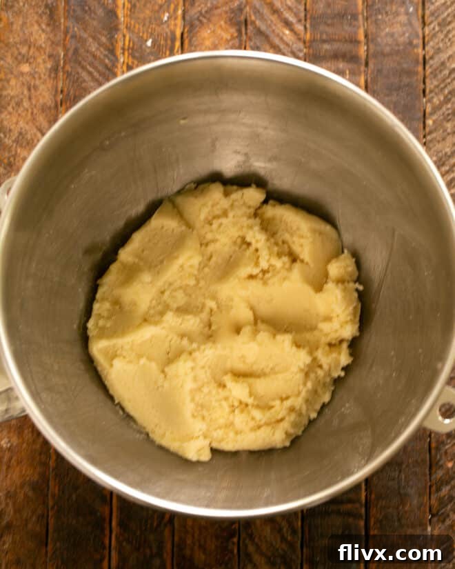 Step 3: Add room temperature butter to the sugars and mix until light and fluffy, then mix in vanilla extract.