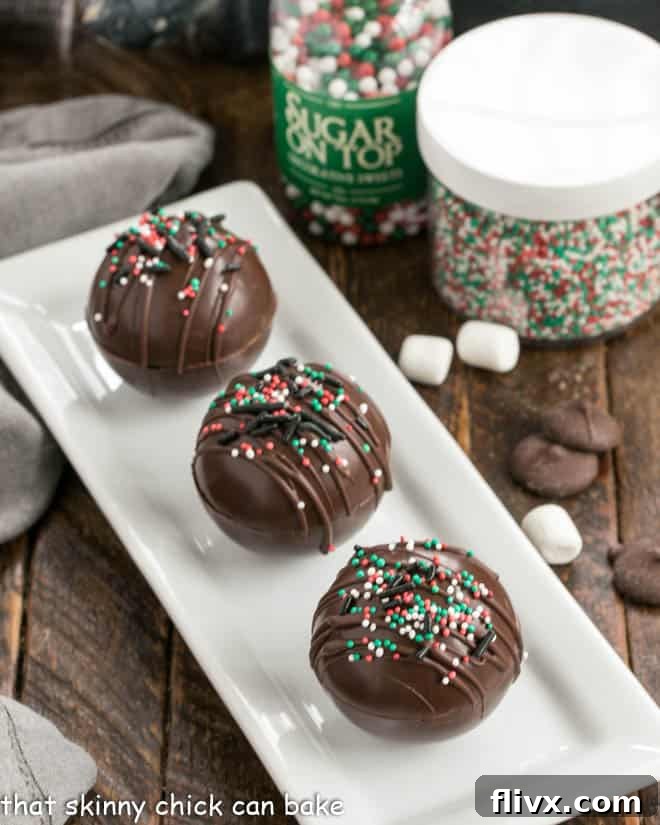 3 hot chocolate bombs on a white tray.