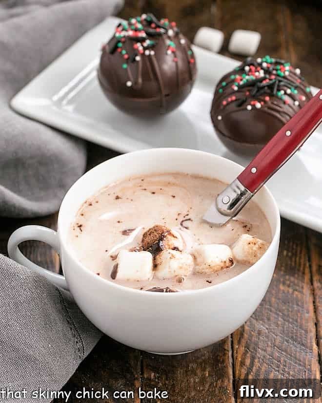 Hot Cocoa Recipe in a white tea cup with a red handle spoon