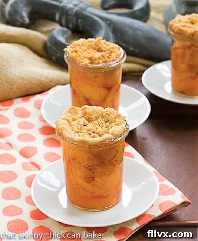 Peach Crisp in Jars on white saucers, showcasing a delightful individual serving of this summer dessert.