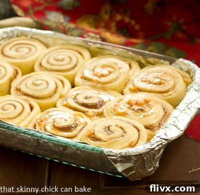 Nectarine Cinnamon Rolls rising in a glass baking dish, ready for the oven.