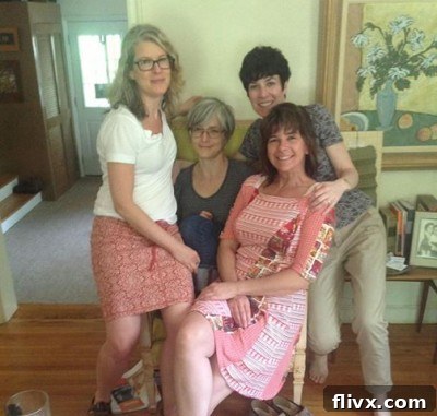 A candid shot of three sisters laughing together in what appears to be a cozy childhood home, evoking warm memories and family bonds.
