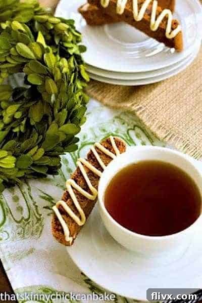Gingerbread Biscotti on a stack of saucers and with a cup of tea, showcasing holiday cheer