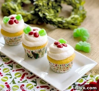 A festive platter of Holly Topped White Cupcakes, beautifully decorated and ready to serve for the holidays or any celebration.