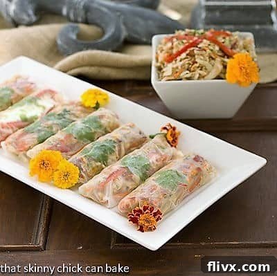 Freshly prepared Asian Cole Slaw Spring Rolls arranged artfully on a rectangular platter, showcasing their vibrant colors and healthy appeal.