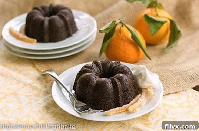 Mini Gingerbread Bundt Cakes on plates with candied orange peel.