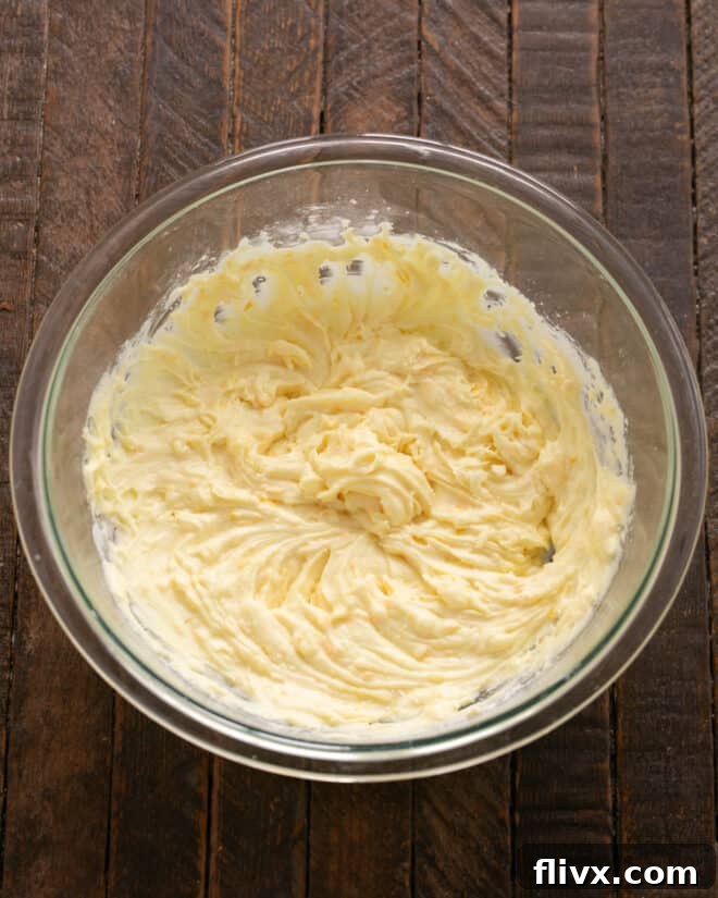 Fluffy Orange Glazed Rolls 10 Orange filling and frosting mixture being beaten until smooth and creamy.