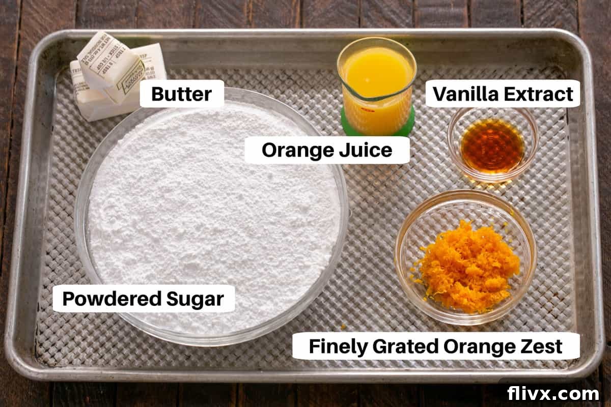 Fluffy Orange Glazed Rolls 3 Ingredients for Orange Rolls Filling and Frosting displayed with labels on a sheet pan, featuring powdered sugar, butter, orange zest, orange juice, and vanilla extract.