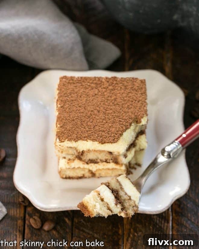 A slice of tiramisu with a forkful removed