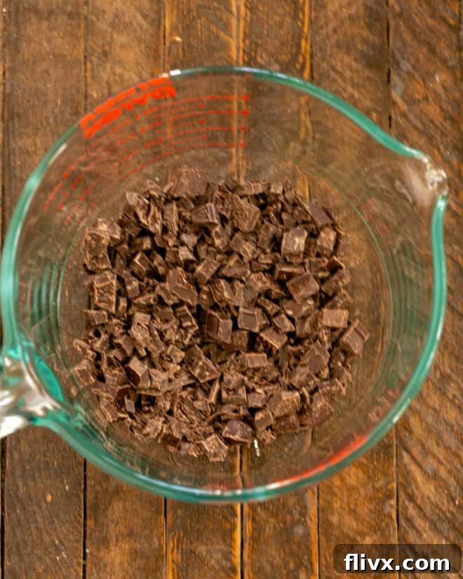 A bowl filled with finely chopped semisweet chocolate, prepared to receive the warm custard for melting.