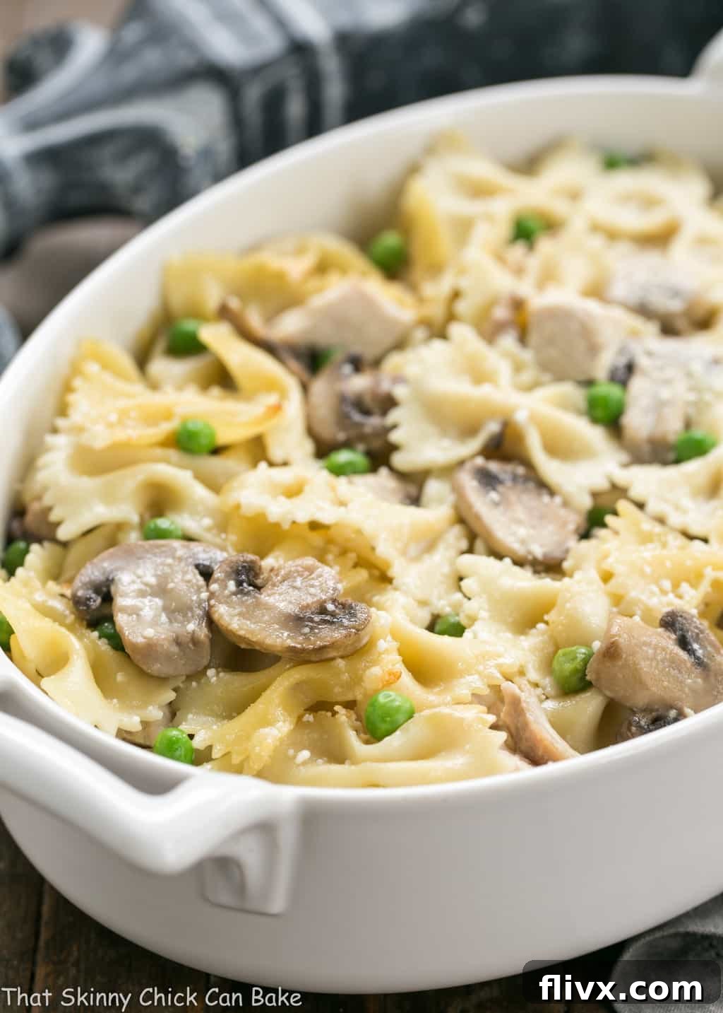 A large, inviting oval casserole dish filled with baked Turkey Tetrazzini, showing its golden-brown top and creamy interior, ready to be served.