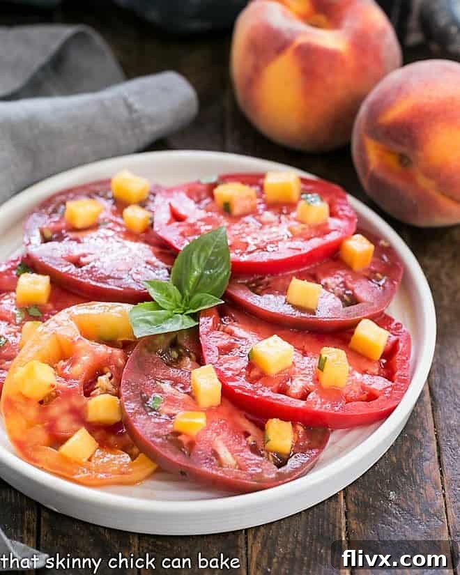 Tomato salad with a peach vinaigrette on a round white plate