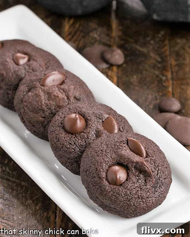 4 chocolate cookie bites on a narrow white ceramic tray.