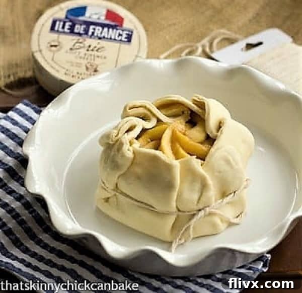 Apple Baked Brie en Croute - an elegant baked brie appetizer that will get rave reviews Apple Topped Baked Brie en Croute ready for the oven, showcasing the artful pastry folds.