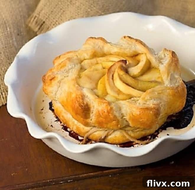 Apple Baked Brie en Croute - an elegant baked brie appetizer that will get rave reviews Apple Baked Brie in a white baking dish before being placed in the oven.