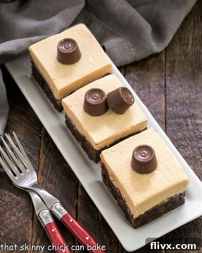 Fudgy Caramel Brownies lined up on a dessert traytopped with Rolo candies