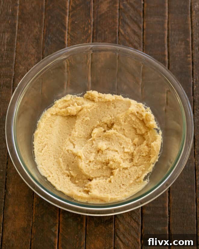 Step 1: Beat room temperature butter with granulated and brown sugars until the mixture becomes light, fluffy, and pale.