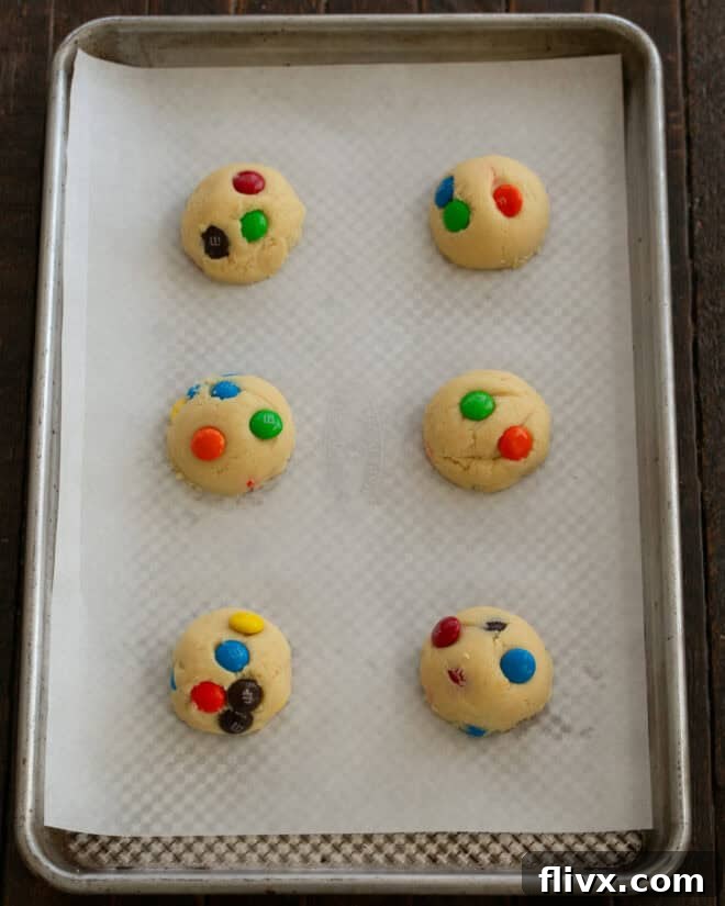 Step 5: Scoop 2 tablespoon balls of cookie dough onto a prepared baking sheet, flattening them slightly if desired, and prepare for baking.